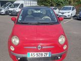 a small red car that is parked in a parking lot