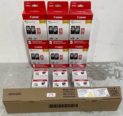 several canon ink cartridges are stacked on top of a cardboard box