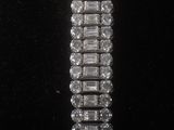 a close up of a bracelet with a lot of diamonds on it