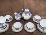 a lot of cups and saucers sitting on a table