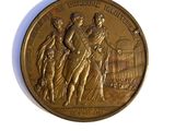 a gold medal on a white surface with a white background