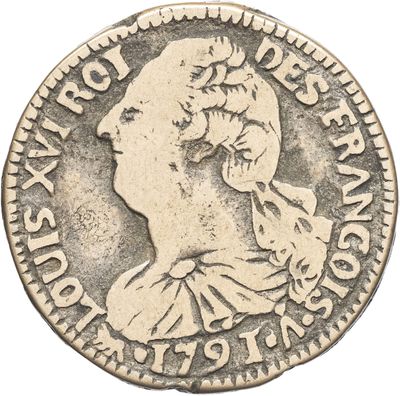 gros plan d'une pièce de monnaie sur laquelle figure un visage de femme