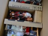 a cardboard box filled with toys and other items