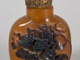a small glass bottle with a flower decoration on it