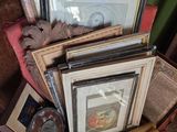 une pile de photos encadrées et une horloge posée sur une chaise