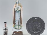 an image of a statue of a woman holding a bottle next to a coin