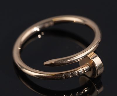 a close up of a gold ring on a black surface