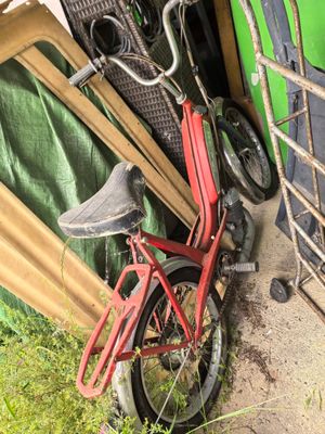 a red bicycle that is parked next to a fence