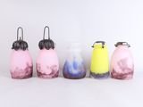 several different colored vases are lined up on a white surface