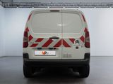 a white van with red and white stripes parked in a garage