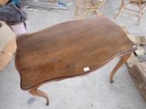 a table that is sitting in the middle of a pile of furniture