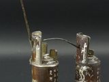 two small tins that are sitting next to each other