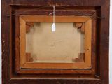 an old wooden picture frame with a tag hanging on it