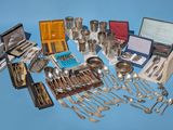 a lot of silverware on a blue surface
