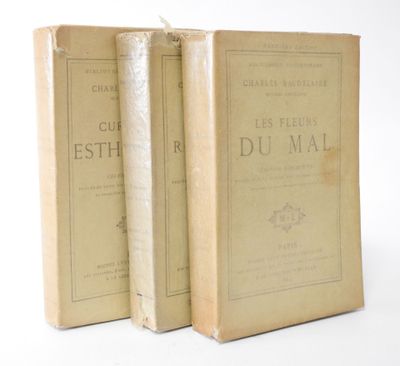 two old books sitting on top of each other on a white surface