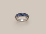 a ring with blue sapphires on a white background