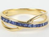 a close up of a gold ring with blue sapphire stones