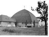black and white photograph of a large building with a large dome on top of it