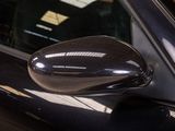 the side view mirror of a car with a reflection of a person in it