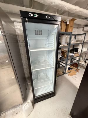 an empty refrigerator in the middle of a room