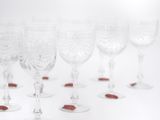 several empty wine glasses are lined up on a white surface