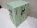 a green box with pictures on it sitting on a table