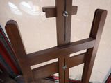 a picture of a wooden easer with a cross on it