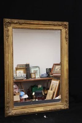 a mirror that is sitting on a shelf in a room