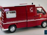 a red ambulance truck with a white roof and a red door