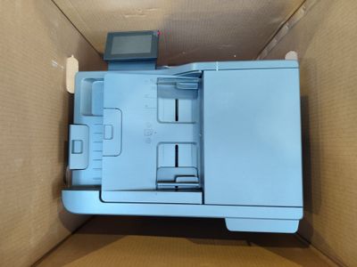 a blue printer sitting inside of a cardboard box
