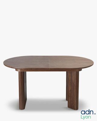 an oval dining table with wooden legs and a wooden top