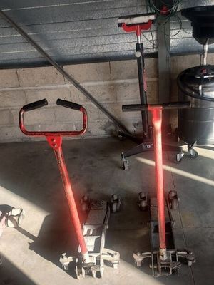 deux crics rouges qui sont rangés dans un garage