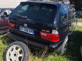 two cars that are parked next to each other in the grass