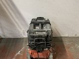 an old engine sitting on the floor in a room