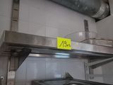 a metal shelf with a sign on it in a kitchen
