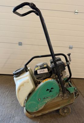 a close up of a small machine on a cart in a garage