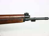 a close up of a rifle on display on a white surface