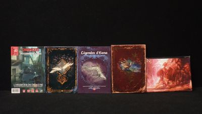 several books are lined up in a row on a black surface