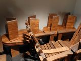 many wooden chairs and a table in a room