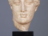 a close up of a statue of a woman ' s head on a table