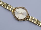 a close up of a gold watch with diamonds on the bracelet