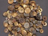 a pile of gold coins on a black surface