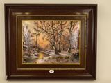 framed oil painting of a winter scene by a stream in a wooded setting