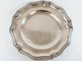 a silver plate on a white table with a white background