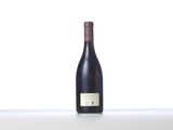 the bottle of wine is sitting on the table with a white background