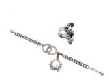 silver bracelet with a peace sign charm and a peace sign charm