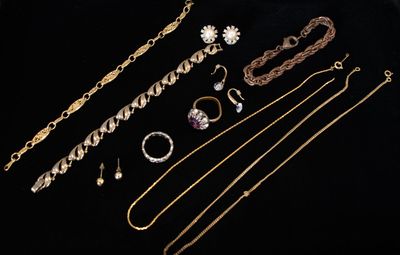 an assortment of gold and silver jewelry including a necklace, bracelet, and ring