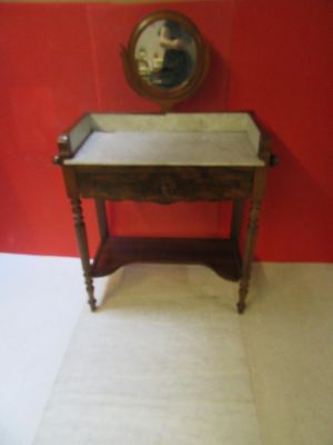 a small wooden table with a marble top in a room