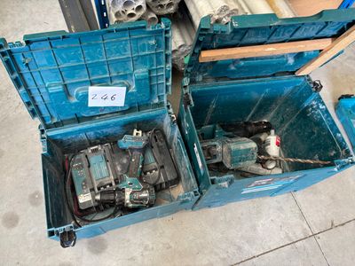 two blue boxes with tools in them on the floor