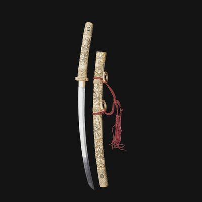a chinese sword with carved handle and sheath